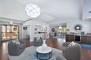 A living room with grey chairs